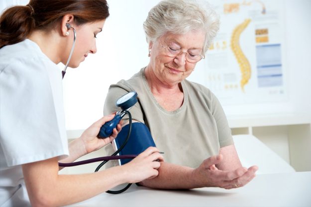Doctor measuring arterial blood pressure of elderly patient with hypertension Doctor measuring arterial blood pressure of elderly patient with hypertension