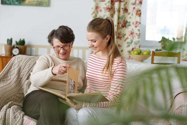 Grandma and granddaughter watching photo album Grandma and granddaughter watching photo album