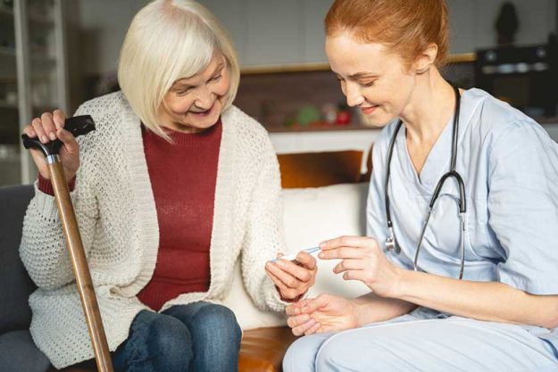 Kind senior female person looking at thermometer