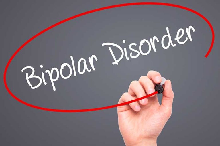 Man Hand writing Bipolar Disorder with black marker Man Hand writing Bipolar Disorder with black marker