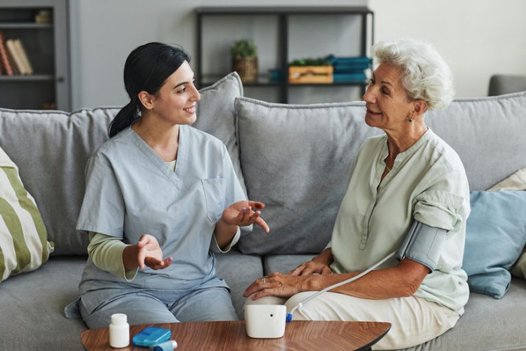 Senior woman talking to young care nurse