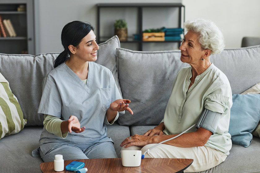 Senior woman talking to young care nurse Senior woman talking to young care nurse