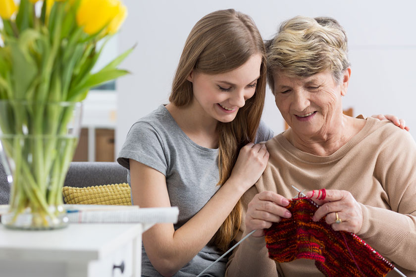 Young woman and her grandma knitting Young woman and her grandma knitting