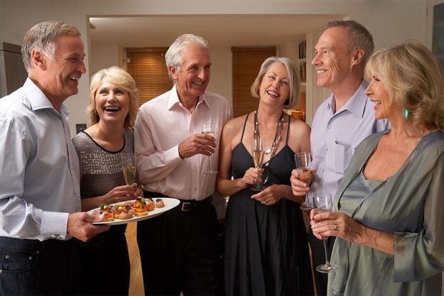 Man Serving Hors D'oeuvres To His Guests