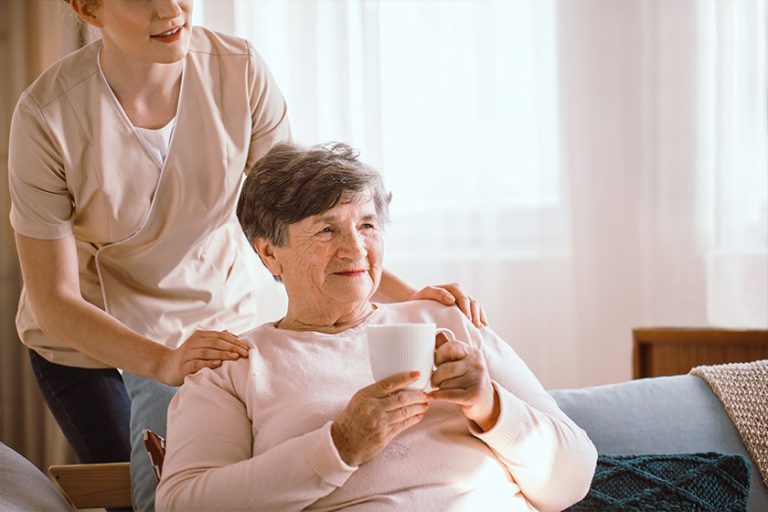 Older woman drinking tea in the living room