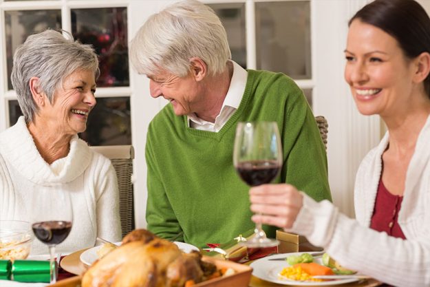 Senior couple laughing at christmas dinner Senior couple laughing at christmas dinner