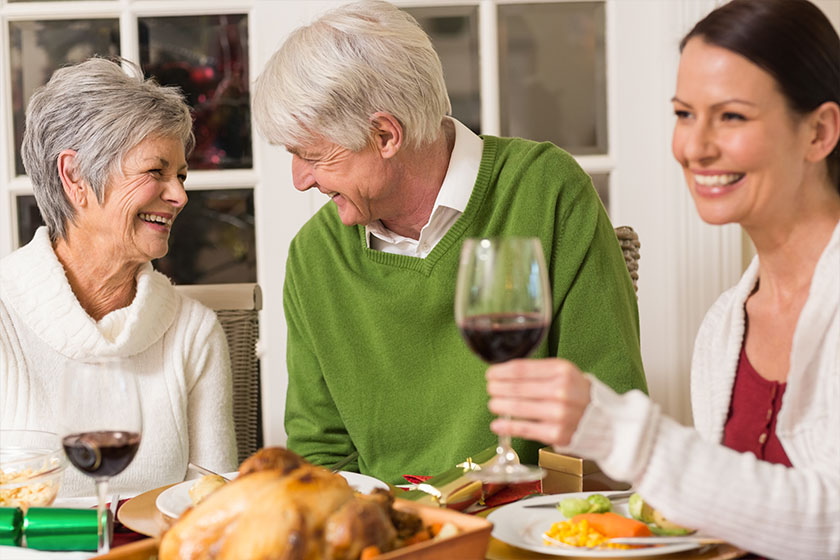 Senior couple laughing at christmas dinner Senior couple laughing at christmas dinner