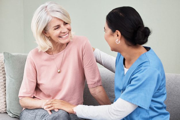Shot of a female nurse sitting with a senior patient