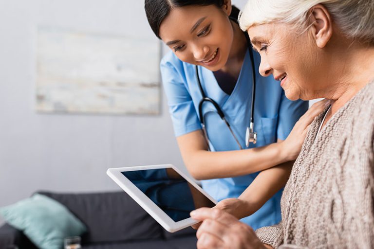 Smiling Asian Nurse Holding Digital Tablet Blank Screen Happy Aged Smiling Asian Nurse Holding Digital Tablet Blank Screen Happy Aged