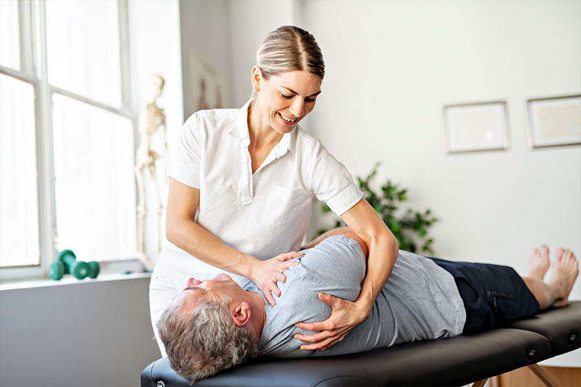 A Modern rehabilitation physiotherapy worker with senior client