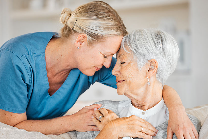 A nurse caring for a senior woman at home