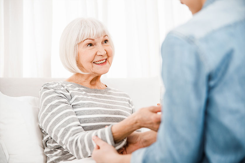 Cheerful elderly woman lying in bed at home Cheerful elderly woman lying in bed at home