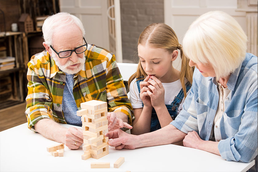 Family playing jenga game Family playing jenga game