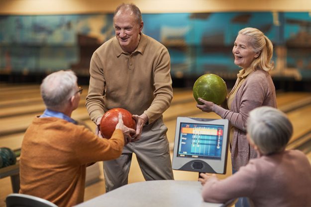 Group of senior people playing bowling together Group of senior people playing bowling together