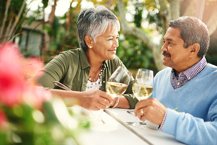 Shot of a happy older couple sharing a toast over lunch outdoors Shot of a happy older couple sharing a toast over lunch outdoors