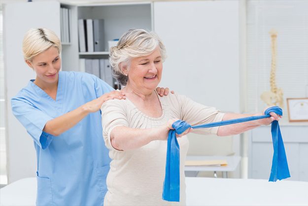 Nurse assisting senior patient in exercising Nurse assisting senior patient in exercising