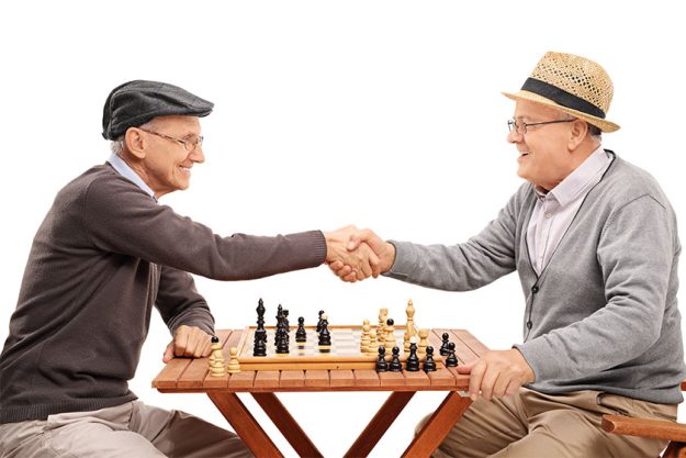 Senior gentlemen shaking hands after a game