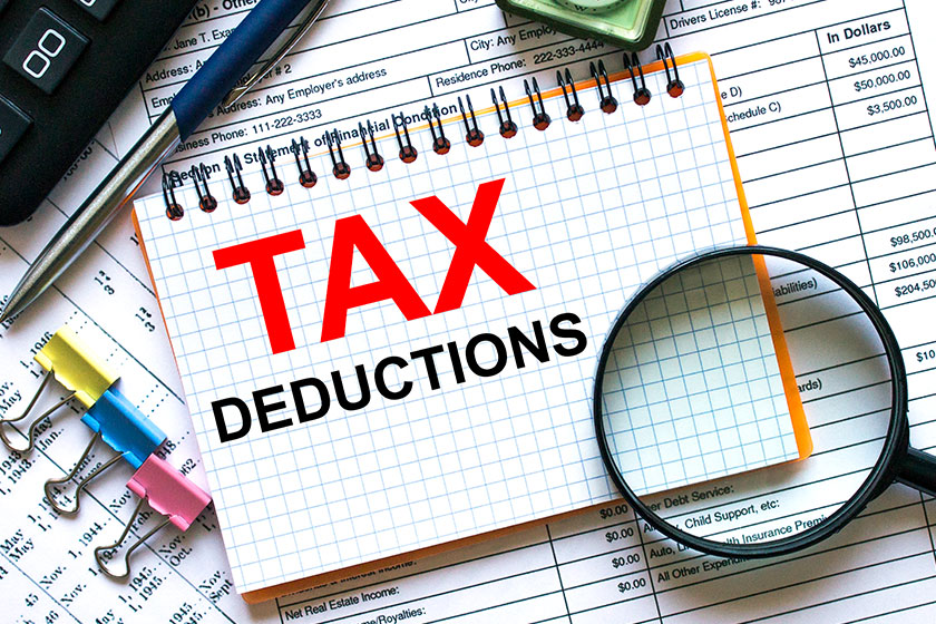 Text Tax Deductions on notepad with calculator