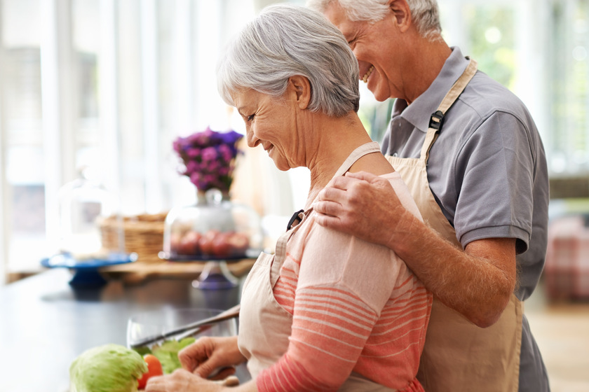We do everything together. Side shot of a couple lovingly preparing a meal together. Here's How Dining Programs In Memory Care Units In Fort Worth, TX Meet Different Needs