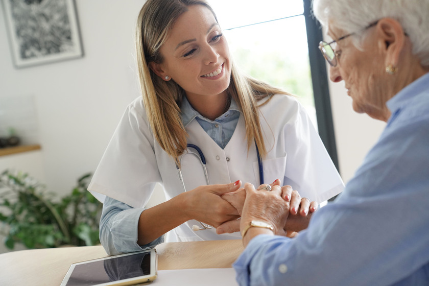 Elderly woman with nurse at home heres-how-our-senior-living-caregivers-in-stuart-fl-communicate-with-residents-with-hearing-impairment