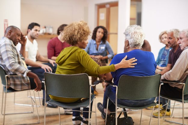 People Attending Self Help Therapy Group Meeting In Community Center How Dementia Activities In Memory Care Services In Grapevine, TX Are Tailored For Different Stages