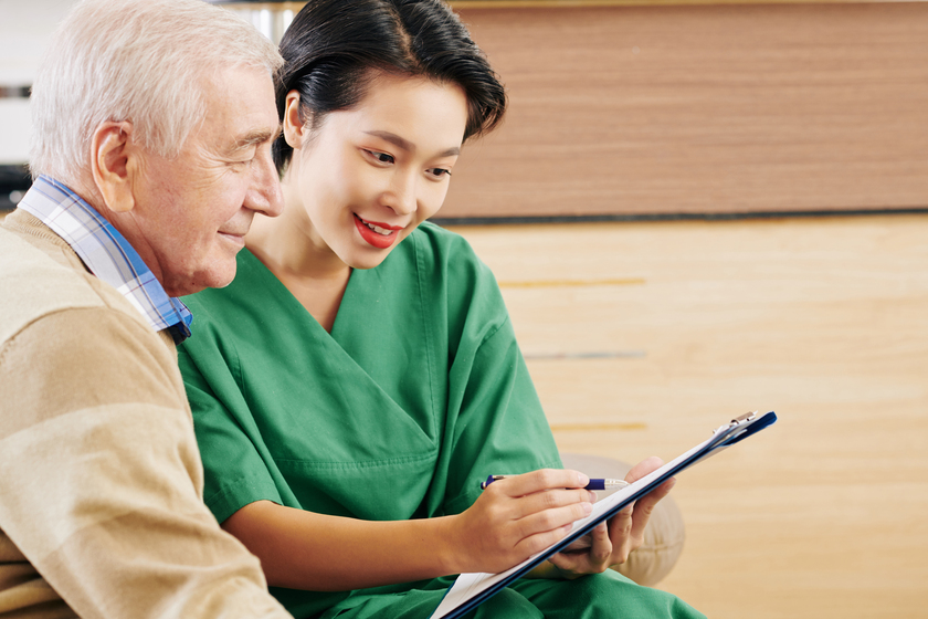 Retiment home volunteer talking to senior man Life Engagement In Grapevine, TX Dementia Care Facilities