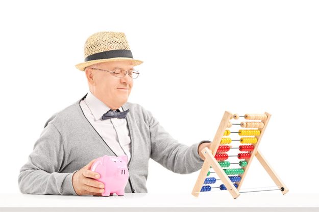 Senior gentleman counting on abacus