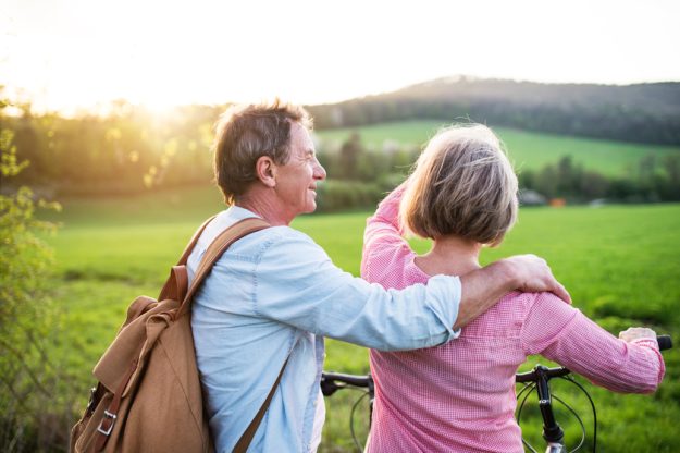 Beautiful senior couple with bicycles outside in spring nature. Sunset Spots To Explore Near Your Senior Home In Allen, TX