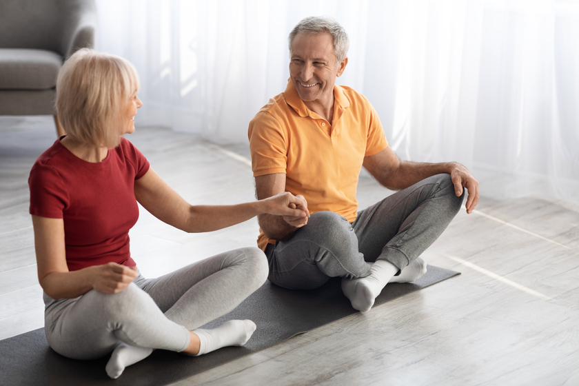 Athletic senior couple meditating together at home The Importance Of Healthy Aging Plans In Alzheimer’s Care In Grapevine, TX