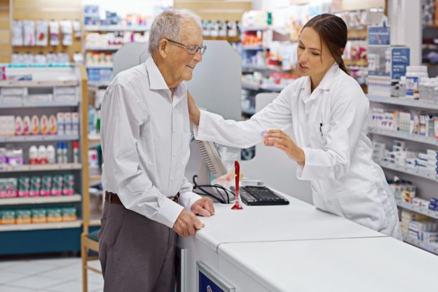 Assuring clients are informed. Shot of a young pharmacist helping an elderly customer at the prescription counter. 10 Important Questions Seniors Should Ask To The Pharmacist
