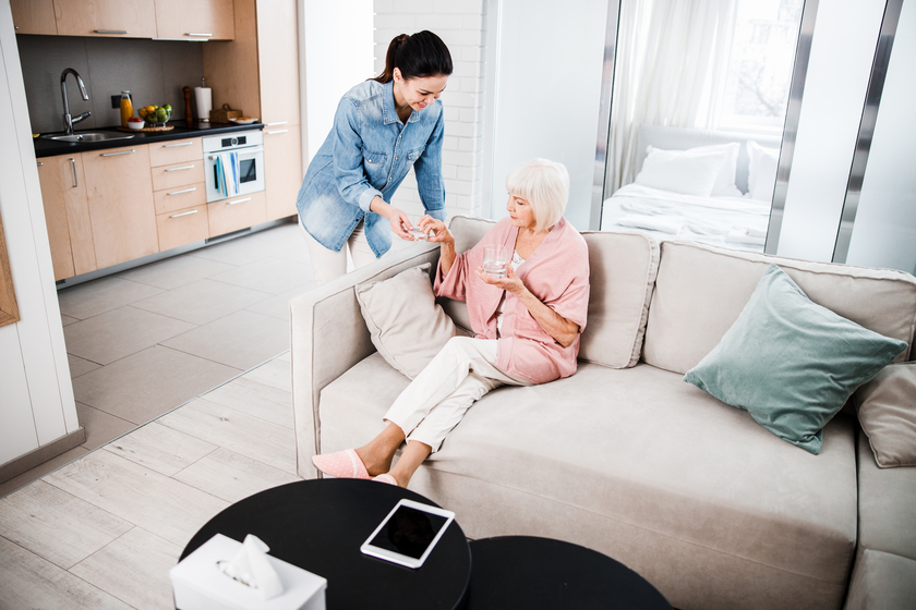 Nice young female helping grandmother to take pills 5 Ways Assisted Living Centers In Fernandina Beach, FL Can Help Seniors Deal With Medication Problems