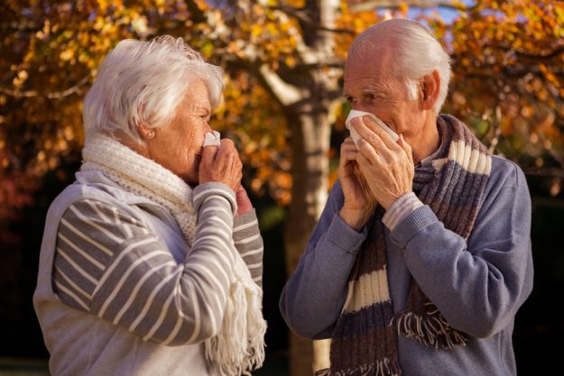 Senior couple using tissues in a park A Guide To Preventing Infections In Assisted Living Apartments In Florida Gardens, FL