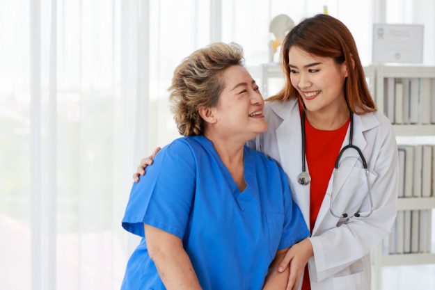 Asian woman doctor holding elderly female arm for help support s How Assisted Living Care In Naples, FL Restores Your Confidence After A Fall