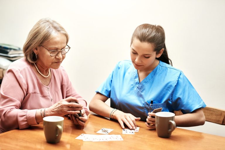 Our time together is special. a senior woman playing cards with her caregiver. How Assisted Living Communities In Fort Myers, FL Will Meets Your Social Needs