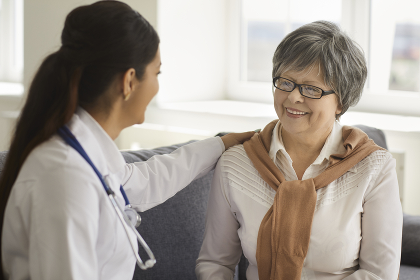 Female doctor consulting senior patient at private clinic closeup portrait