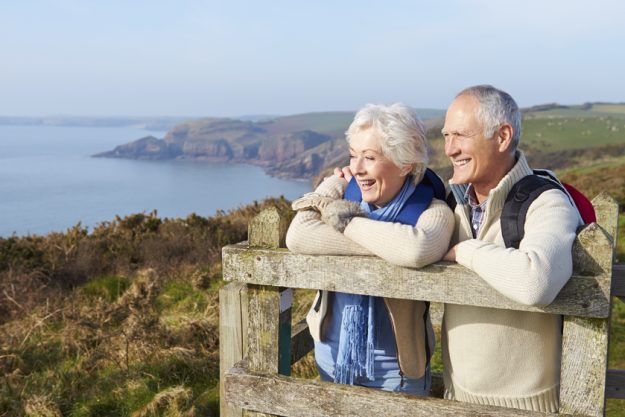 Senior Couple Walking Along Coastal Path
