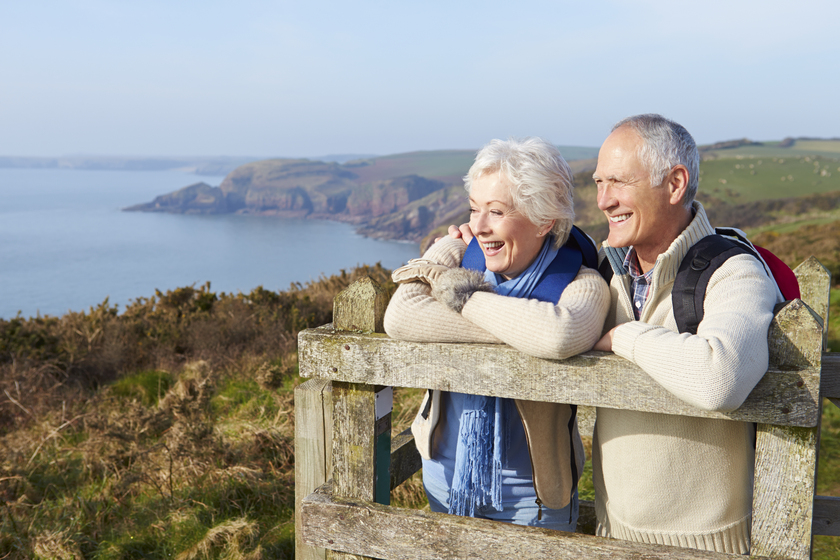 Senior Couple Walking Along Coastal Path Senior Couple Walking Along Coastal Path