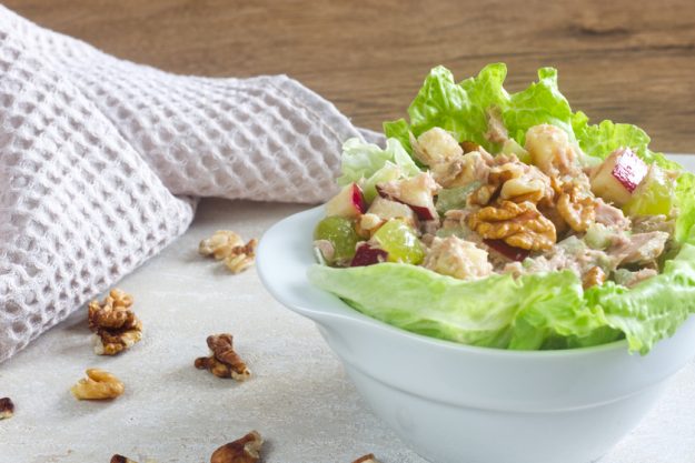 Homemade waldorf salad made of celery, apples and walnuts, served on a bed of fresh leaf lettuce. Homemade waldorf salad made of celery, apples and walnuts, served on a bed of fresh leaf lettuce.