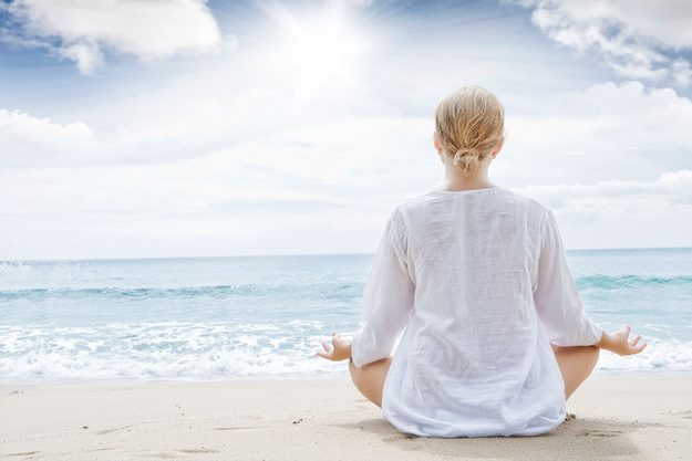 A Female Doing Yoga on the Beach A Female Doing Yoga on the Beach