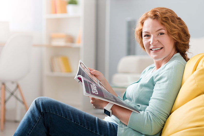 Cheerful senior woman sitting on the couch Cheerful senior woman sitting on the couch