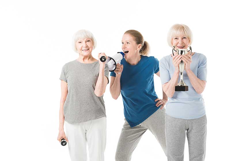 Coach with megaphone and sportswomen Coach with megaphone and sportswomen