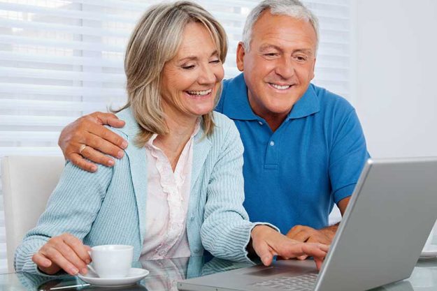 Happy Couple Using Laptop Happy Couple Using Laptop