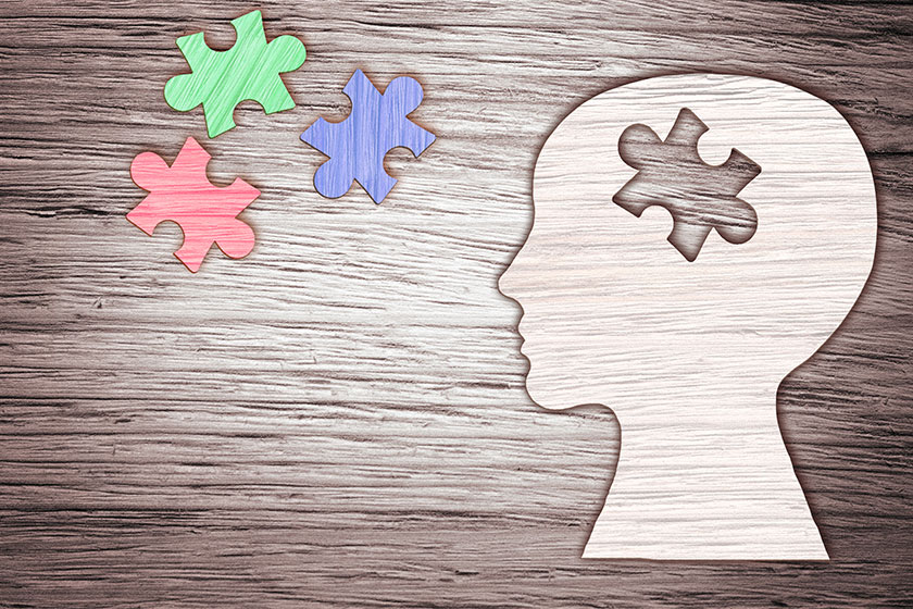 Human head silhouette with a jigsaw piece cut out Human head silhouette with a jigsaw piece cut out