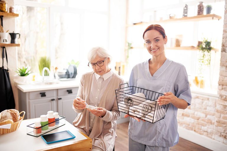Personal caregiver standing near retired woman Personal caregiver standing near retired woman