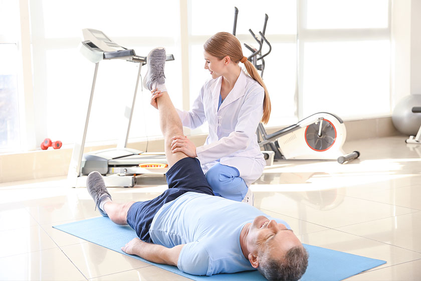 Physiotherapist working with mature patient Physiotherapist working with mature patient