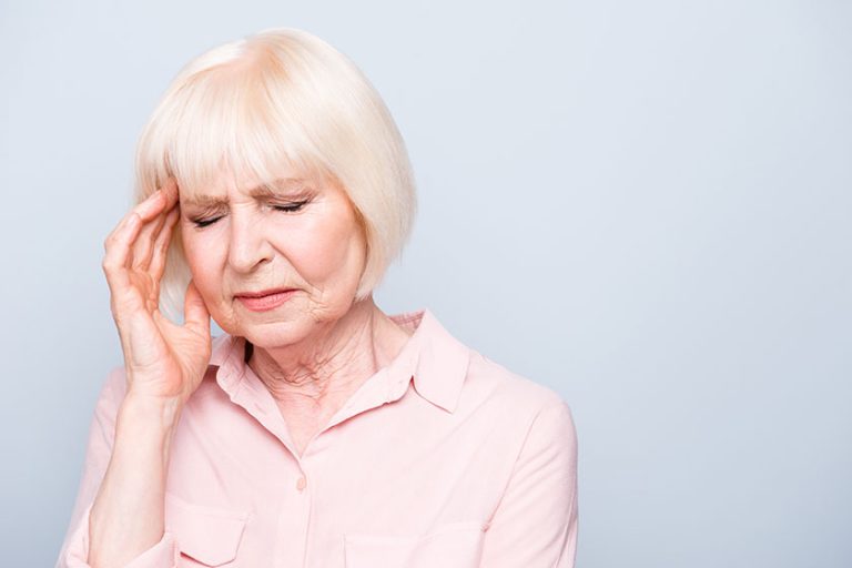Portrait of old adult caucasian lady feeling head ache