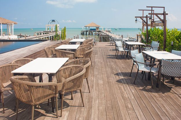 Rows of wooden chair and table locate on terrace Rows of wooden chair and table locate on terrace