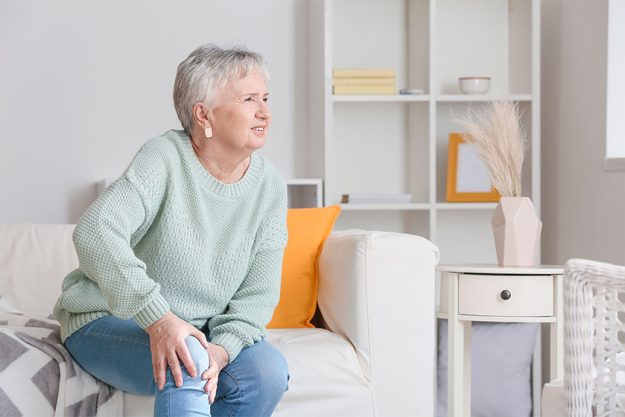 Senior woman suffering from pain in knee Senior woman suffering from pain in knee