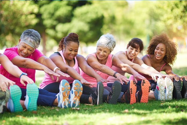 Shot of a group of people warming up outdoors