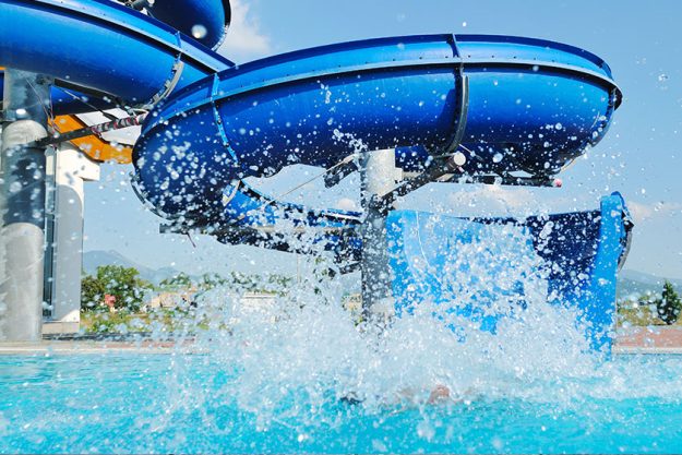 Water slide fun on outdoor pool Water slide fun on outdoor pool